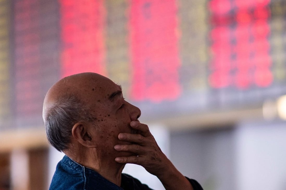 An investor looks at stock information at a brokerage house in Shanghai on October 15. Photo: AFP