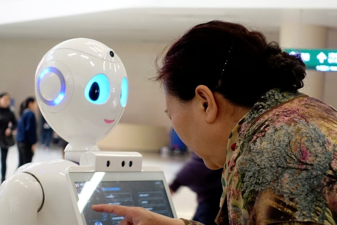 A woman touches a screen on a robot developed by iFlyTek at the outpatient hall of People's Liberation Army General Hospital in Beijing. Natural language processing has been considered one of the holy grails in AI. Photo: Reuterss