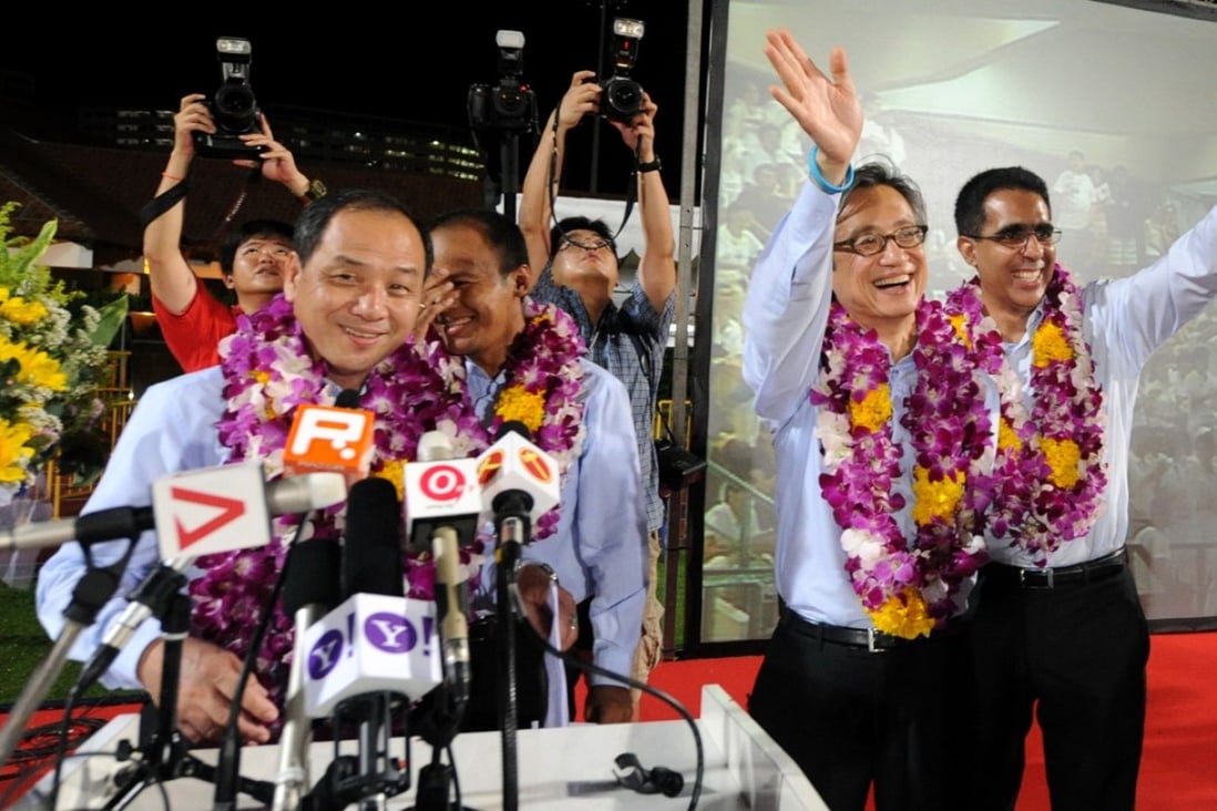 Low Thia Khiang (L) smiles with other candidates of the Workers' Party after winning five seats in the Singapore general election in 2011. Photo: AFP