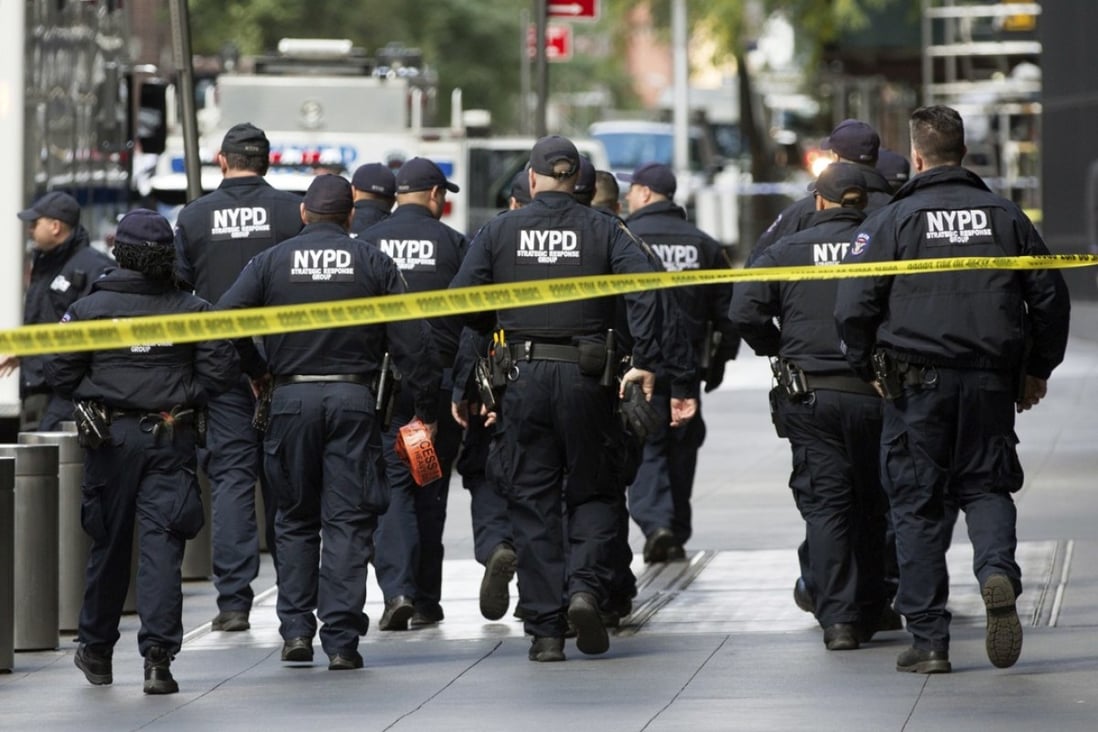 NYPD officers depart from the Time Warner Centre area in New York on Wednesday after a pipe bomb triggered the evacuation of CNN's offices. Photo: AP
