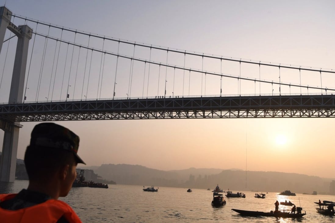 Rescuers working Sunday underneath the bridge over the Yangtze River in Chongqing, after a bus plunged into the river. While recovery operations continue, commenters on social media have criticised the woman driver of the car that the bus hit prior to its plunge. Photo: Xinhua