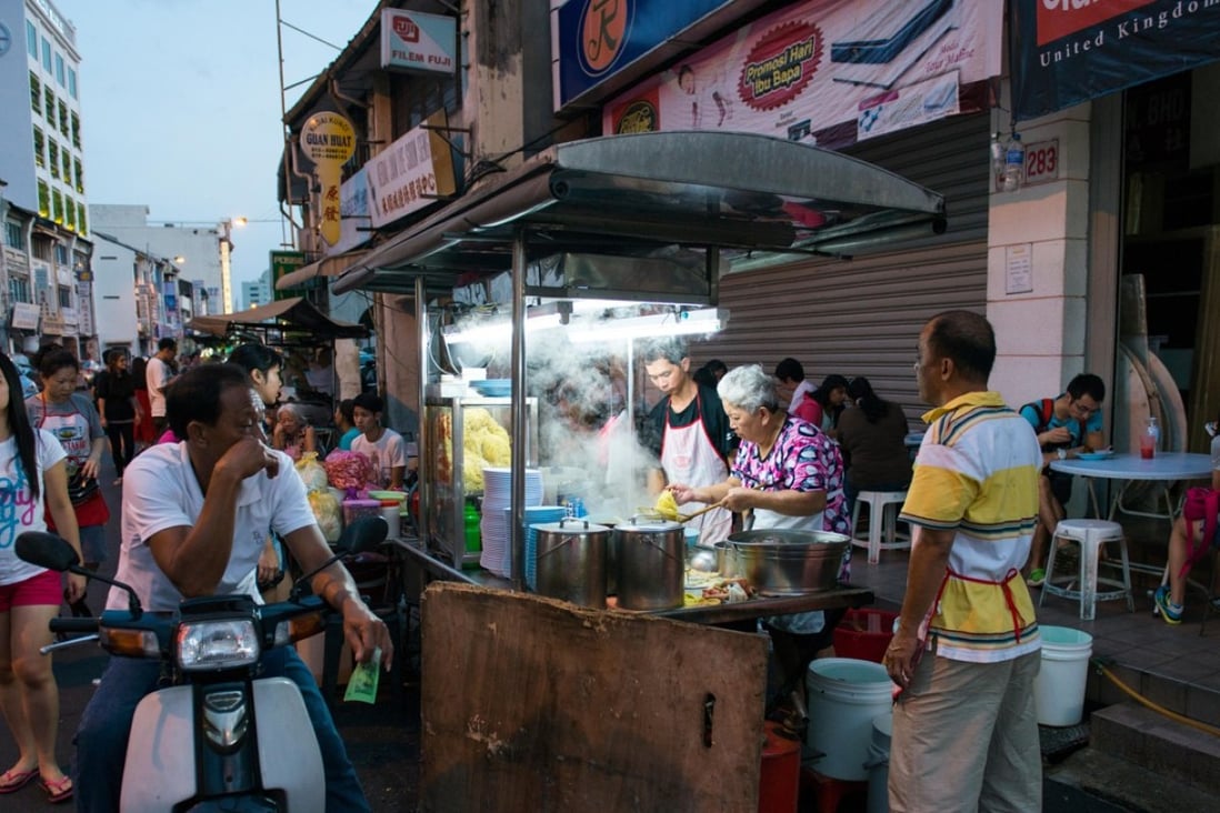 A food stall on a street in Malaysia. Locals don’t want to work in the food and beverage trade, restaurant owners say. Photo: Alamy