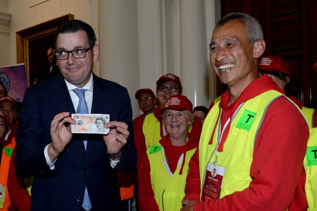 Victorian Premier Daniel Andrews holds a British ten pound note at a function to formally apologise to descendants of Chinese migrants who were targeted by a racist ten pound tax some 160 years ago. Photo: EPA