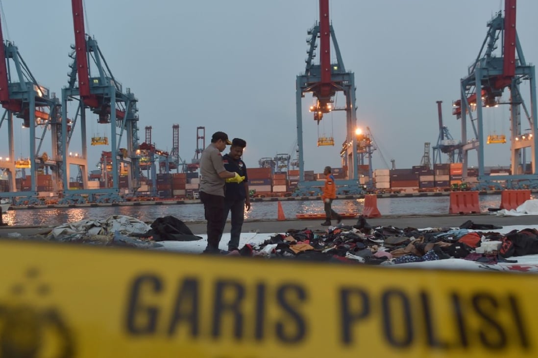 Indonesian policemen examining debris of the ill-fated Lion Air flight. Photo: AFP