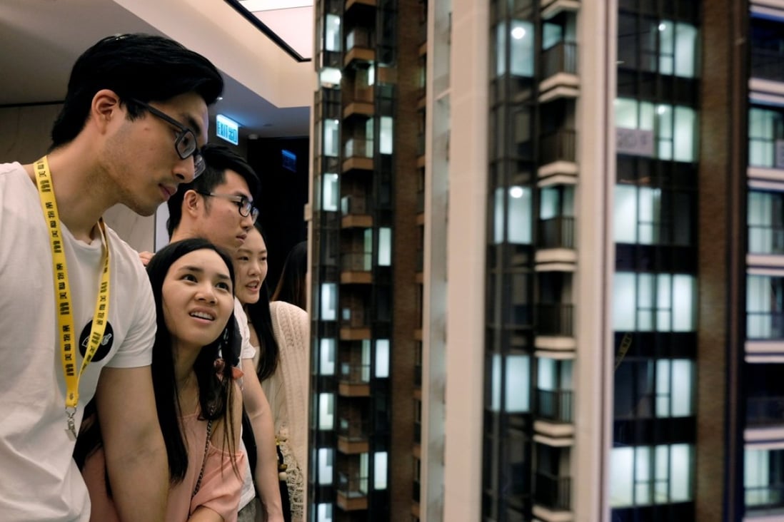 Prospective buyers looking at a model of the LP6 property development by Nan Fung Group at a sales centre in Hong Kong on August 26. Photo: Reuters