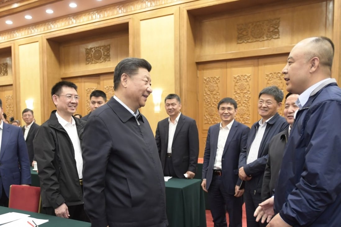 Chinese President Xi Jinping (left, front) talks to private entrepreneurs during a symposium at the Great Hall of the People in Beijing on Thursday. Photo: Xinhua