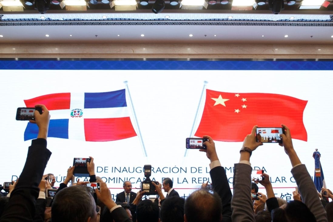 People take pictures during the opening ceremony of the Dominican Republic's embassy in Beijing. Photo: AFP