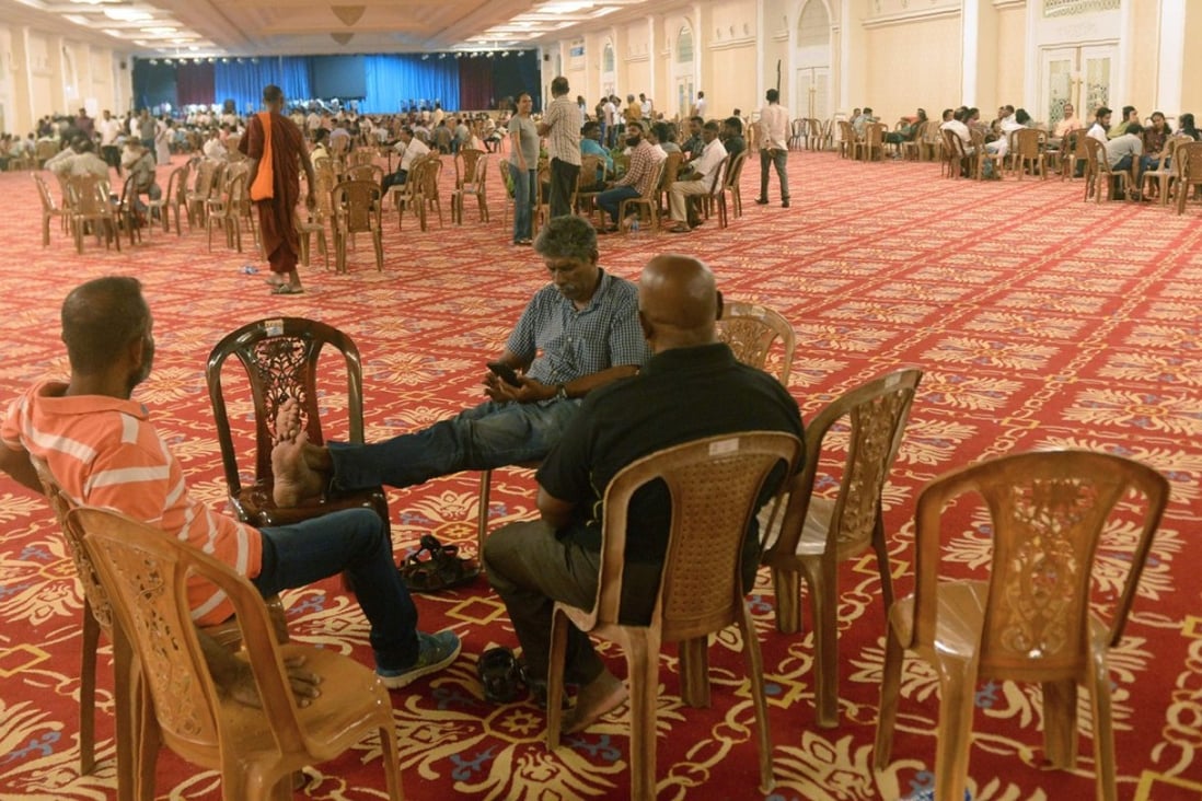 Supporters of Ranil Wickremesinghe occupy the banquet hall at the sacked PM’s official residence. Photo: AFP