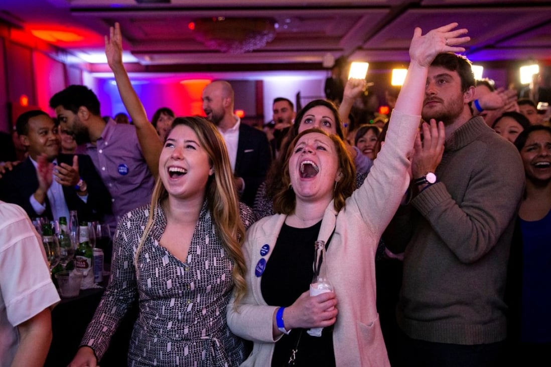 Alyssa Giammarella and Claire Viall cheer as they watch election results come in at a Democratic election night rally in Washington. Photo: Reuters