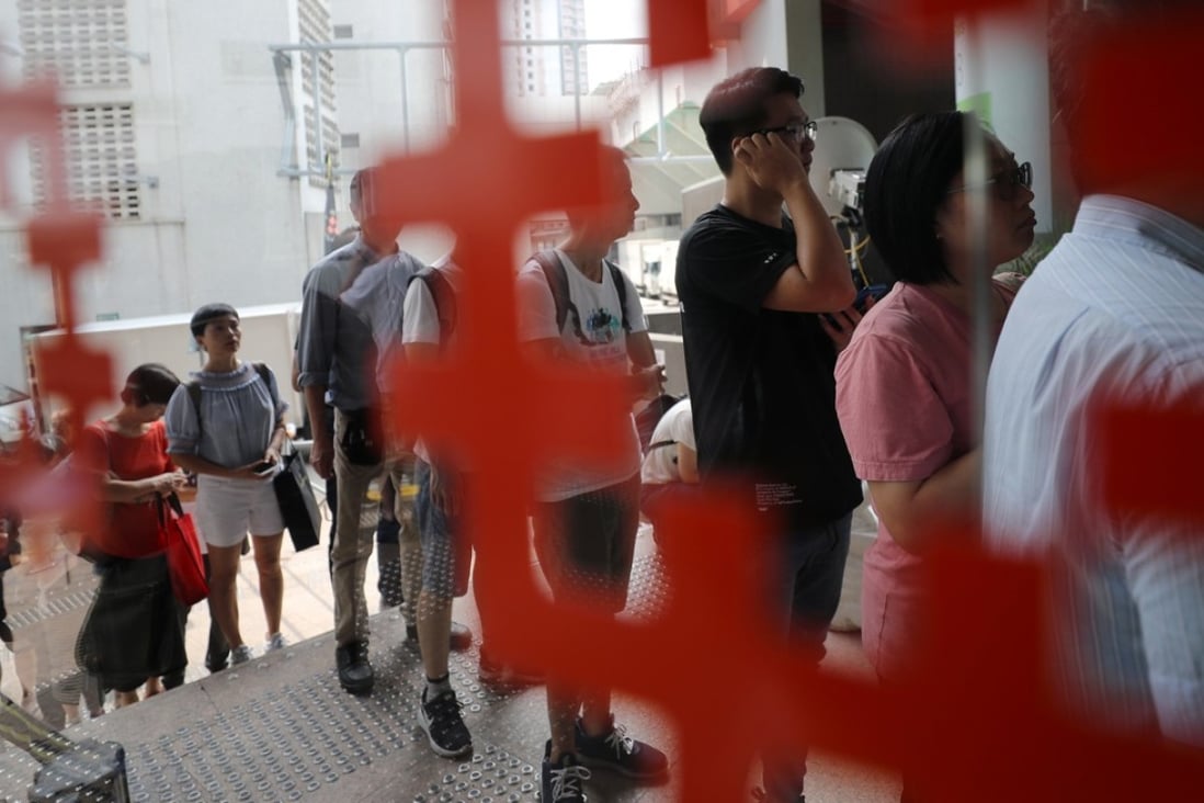 Interested applicants for the Sale of Home Ownership Scheme Flats 2018 pick up application forms at the Lok Fu Housing Authority office. Photo: Edward Wong