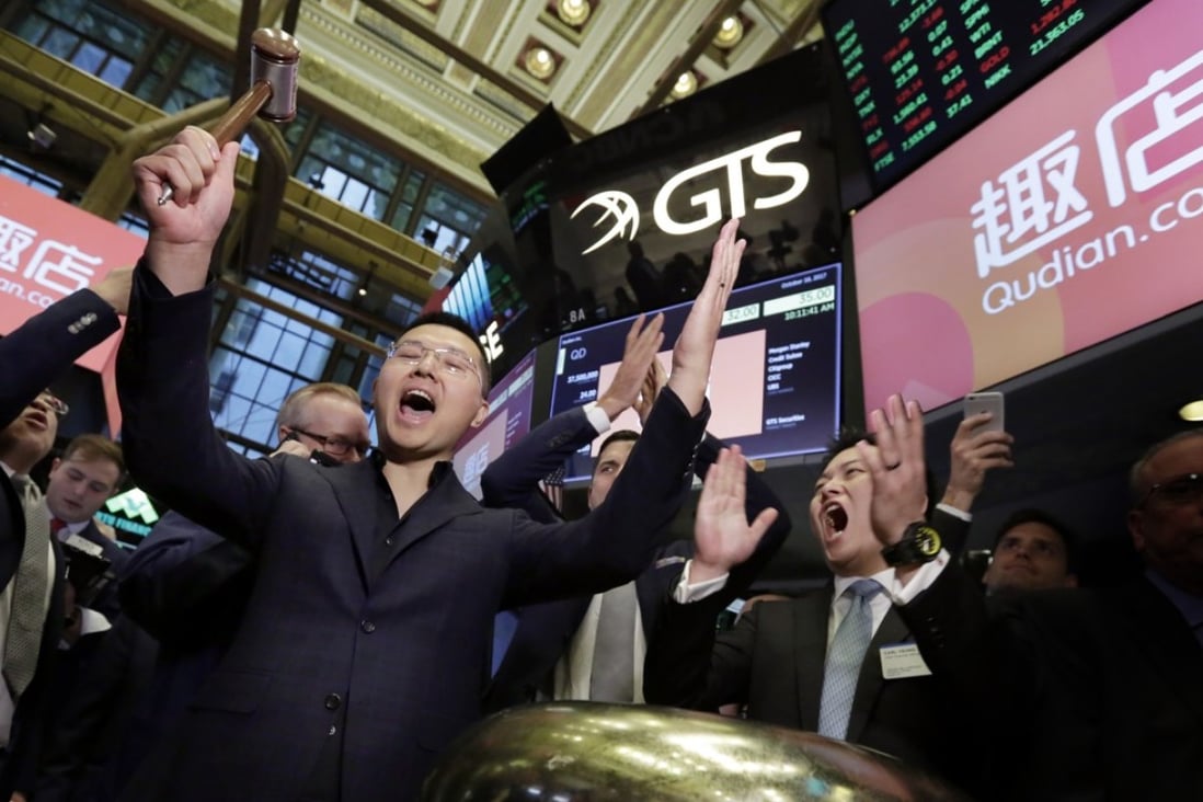 CEO Min Luo (left) and chief financial officer Carl Yeung of online payday loan platform Qudian celebrate as their company’s shares start trading on the New York Stock Exchange on October 18, 2017. The company has since seen its share price tumble amid social media criticism of its high interest rates and regulatory tightening in China. Photo: AP