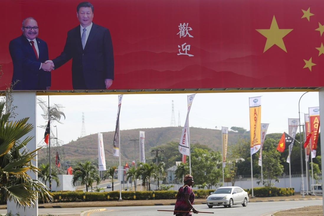 A woman passes by a poster of Papua New Guinea Prime Minister Peter O'Neill and Chinese President Xi Jinping, ahead of the Apec summit in Port Moresby, Papua New Guinea, which will be held this weekend. Photo: EPA-EFE