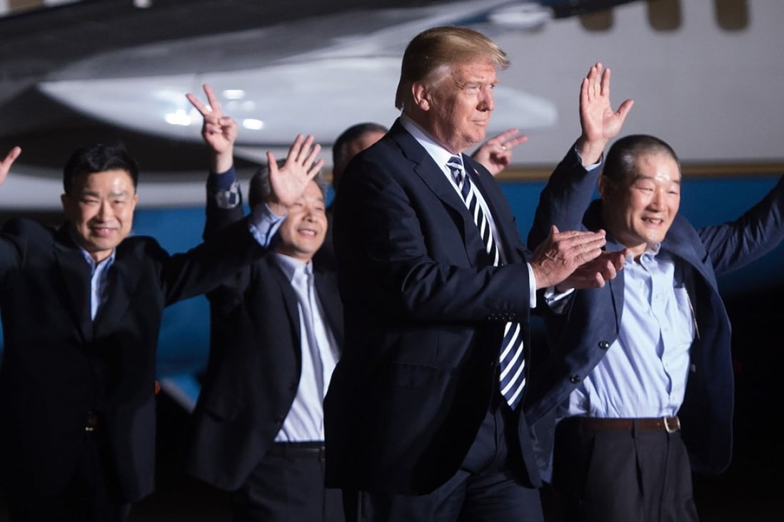 US President Donald Trump walks with US detainees Tony Kim, Kim Hak-song and Kim Dong-chul upon their return after they were released by North Korea. Photo: AFP