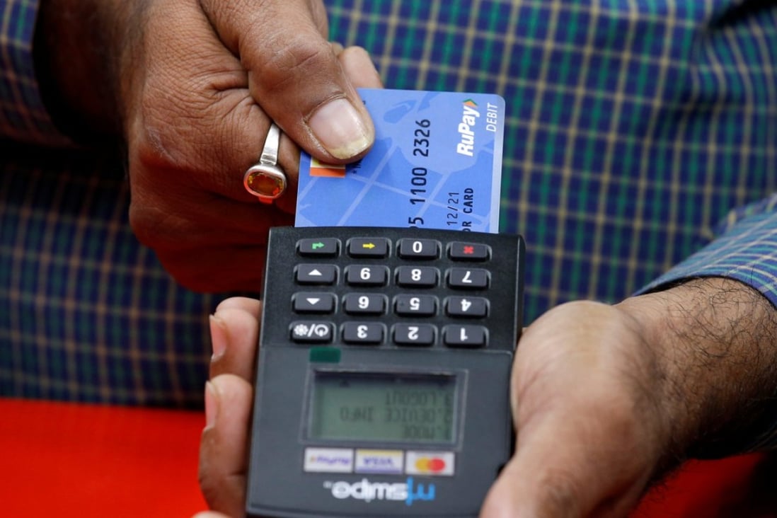 A shopkeeper swipes a customer’s debit card featuring the logo of home-grown Indian payment system RuPay. Photo: Reuters