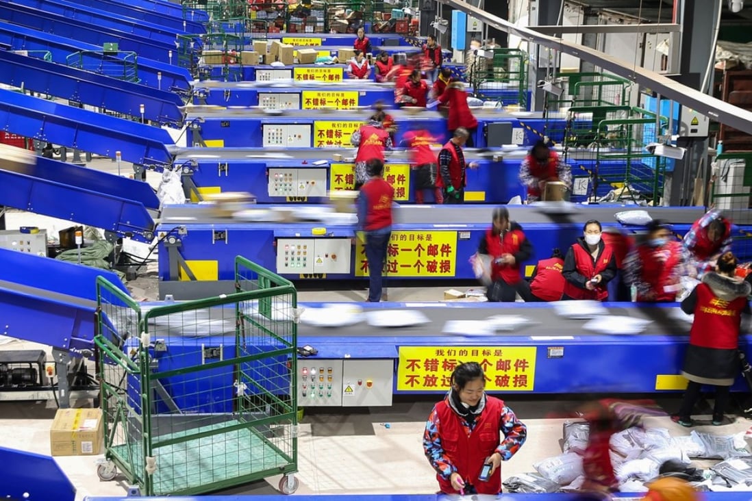 Workers sort packages after the Singles' Day shopping festival at a delivery company in Hengyang, China, on November 12. Photo: AFP