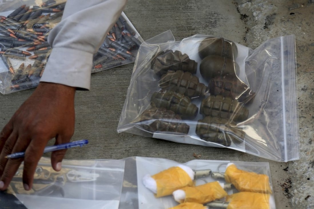 An investigation officer checks ammunition recovered from an attack on the Chinese Consulate in Karachi, Pakistan on November 23, 2018. Photo: AP