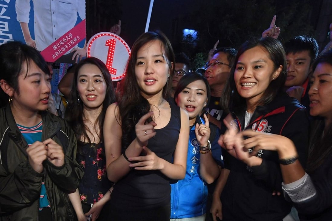 Coco Han (centre) turned her hand and her organisational skills to helping her father, the KMT Kaohsiung mayoral candidate Han Kuo-yu. Their message struck a chord with young and social media-aware voters. Photo: CNA
