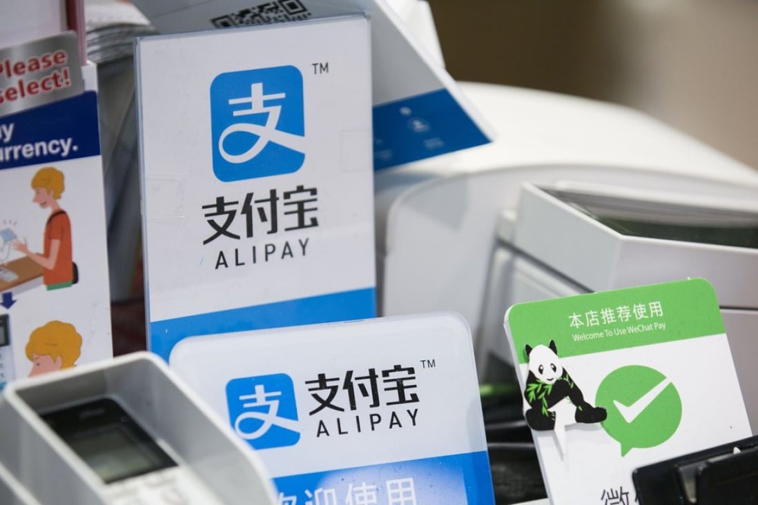 Signs for Alipay and Tencent’s WeChat Pay at a Takeya Co. Ueno Select shop in Tokyo, Japan, on Saturday, December, 2017. Photo: Bloomberg