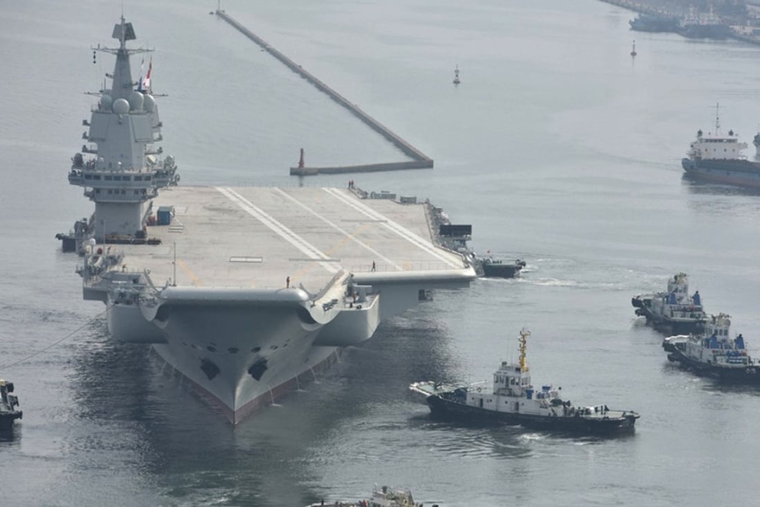 The Type 001A home-grown aircraft carrier leaves its dock in Dalian shipyard in China's northeastern Liaoning province. Photo: DFIC
