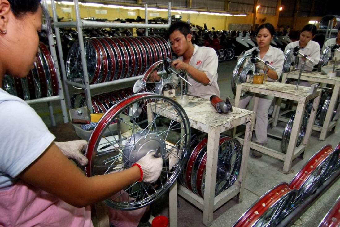 Workers assemble motorcycle parts at a joint venture of Chinese motorcycle company Lifan in Hung Yen Province, Vietnam. Research contends that China has in recent years lost some of its competitive advantage to emerging neighbours such as Vietnam and Malaysia. Photo: Xinhua