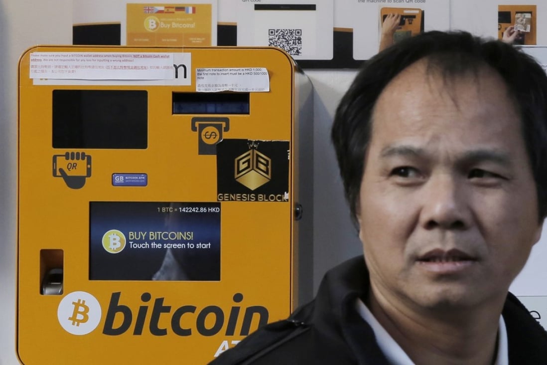 A man walks past the Bitcoin ATMs in Hong Kong, Thursday, Dec. 21, 2017. Bitcoin is the world's most popular virtual currency. Such currencies are not tied to a bank or government and allow users to spend money anonymously. They are basically lines of computer code that are digitally signed each time they are traded. (AP Photo/Kin Cheung)
