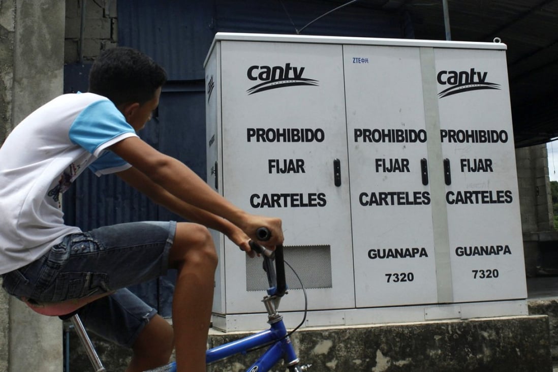 A man rides past a routing box for phone lines, installed by ZTE for Venezuela's national telecommunications company CANTV in Barinas, Venezuela, in this September file photo. Photo: Reuters