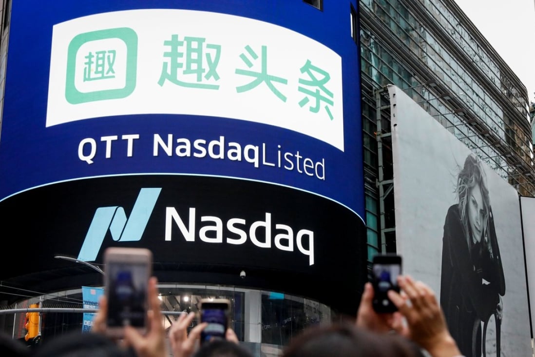 Guests of Qutoutiao Inc. photograph the company's logo, during its IPO, on a screen at the Nasdaq MarketSite in New York City, September 14, 2018. Photo: Reuters