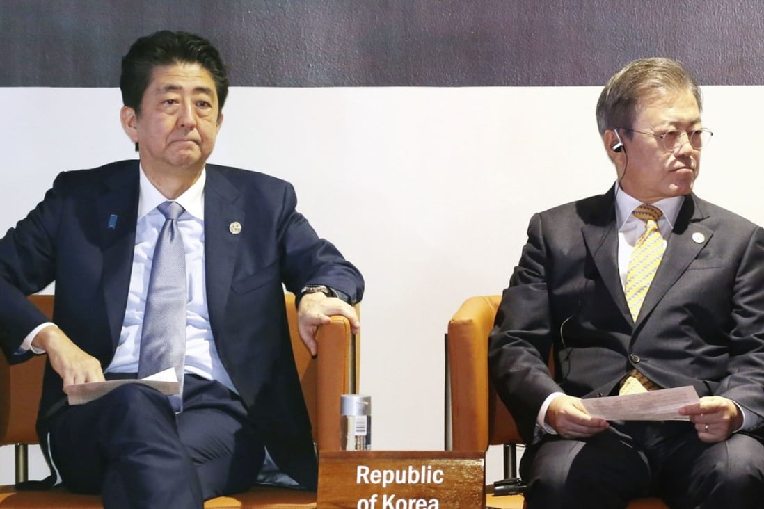 Japanese Prime Minister Shinzo Abe (left) and South Korean President Moon Jae-in. Photo: Kyodo