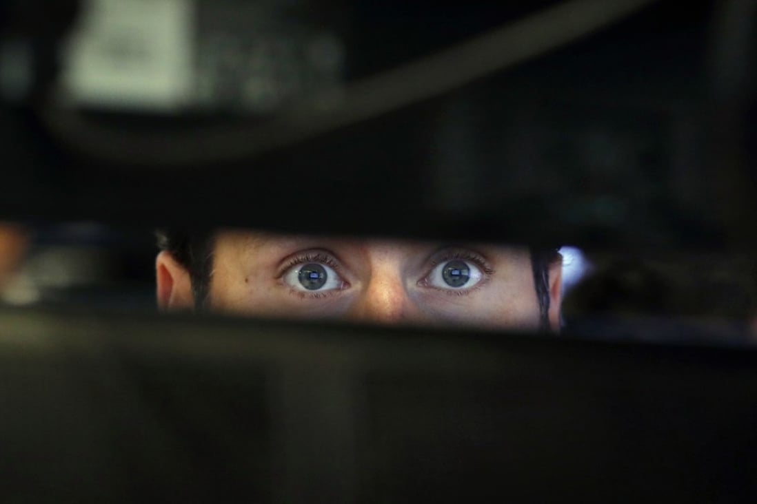 Specialist Michael Pistillo watches the screens at his post on the floor of the New York Stock Exchange on November 28. Photo: AP