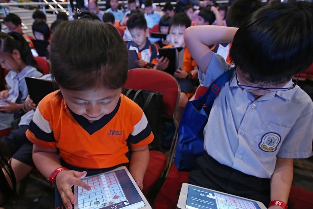 Students at the Chinese Chess Challenge "1K VS AI" Battle Day at Queen Elizabeth Stadium in Wan Chai. 1000 students play against Chinese chess artificial intelligence (AI) systems to compete for the championships of the primary and secondary categories and attempt to set a world record for "The Most People Battling Against an Artificial Intelligence Chinese Chess System on the Spot Simultaneously". Photo: David Wong