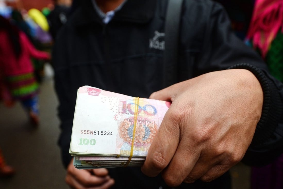 A man carries cash in the border district between Vietnam's Ha Giang province and China. Many single Chinese men are turning to buying brides from poor Mekong countries like Vietnam. Photo: AFP