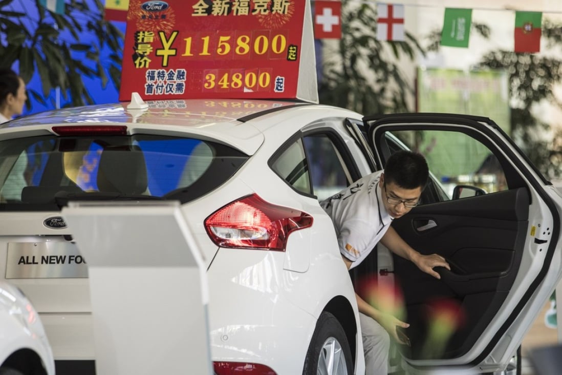 A customer steps out of a Ford Motor Co. vehicle on display at a Ford dealership in Shanghai, China. The US-China trade war will take a toll on companies from both sides, with some tariffs in place and the potential to escalate into consumer boycotts. Photo: Bloomberg