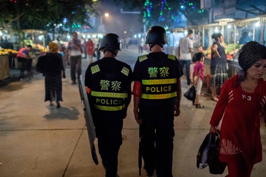 Police patrol a market near the Id Kah Mosque in Kashgar, Xinjiang. Photo: AFP