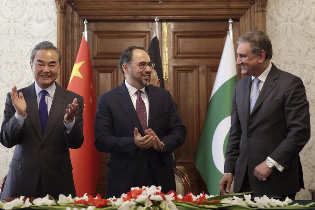 From left: China’s Foreign Minister Wang Yi, Afghanistan’s Minister of Foreign Affairs Salahuddin Rabbani, and Pakistan’s Foreign Minister Shah Mehmood Qureshi are all smiles after signing an agreement on security cooperation. Photo: AP