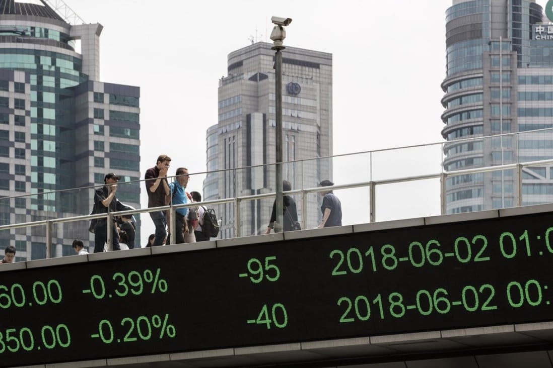 Pedestrians on an elevated walkway that displays stock figures at Lujiazui financial district in Pudong, Shanghai. China’s bond market is optimistic about further stimulus to the economy, but the stock market is pessimistic. Photo: Bloomberg