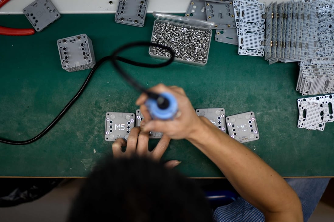 An employee of a robot-producing company at work in Shenzhen. Photo: AFP