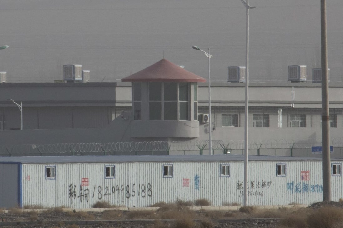 A guard tower and barbed wire fences around an internment facility in Xinjiang. Photo: AP