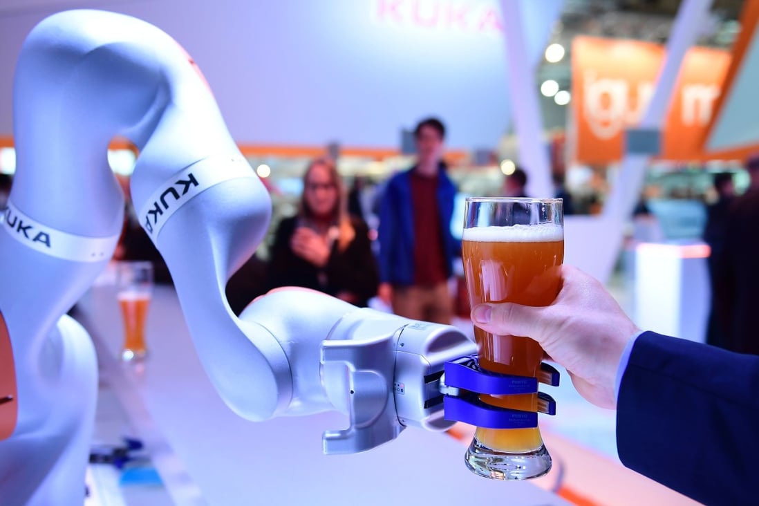 A Kuka robot serves beer at the Hanover Fair in Germany on April 24, 2017. The acquisition of the German industrial robotics manufacturer by appliance maker Midea in 2016 has led to concerns about investments by Chinese companies in Europe. Photo: AFP