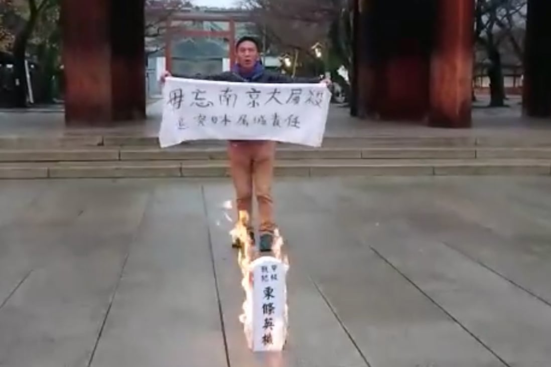 Alex Kwok at the shrine setting fire to a symbolic ancestral tablet condemning country’s war criminal. Photo: Facebook