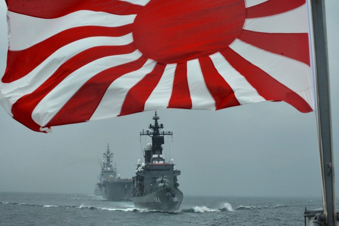File photo of a flag of the Japanese Maritime Self-Defence Force and escort ships Kurama and Hyuga off Sagami Bay, Kanagawa prefecture. Photo: AFP