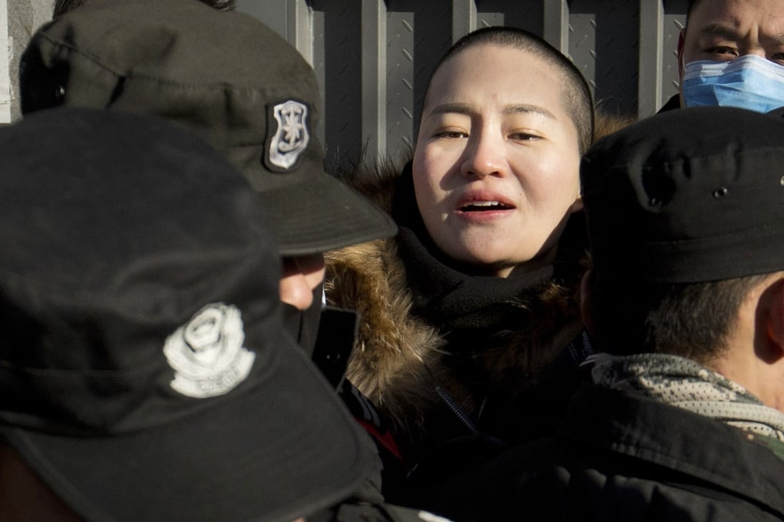 Security officers surround Li Wenzu as she attempts to enter the Supreme People’s Court petition office in Beijing on Friday. Photo: AP