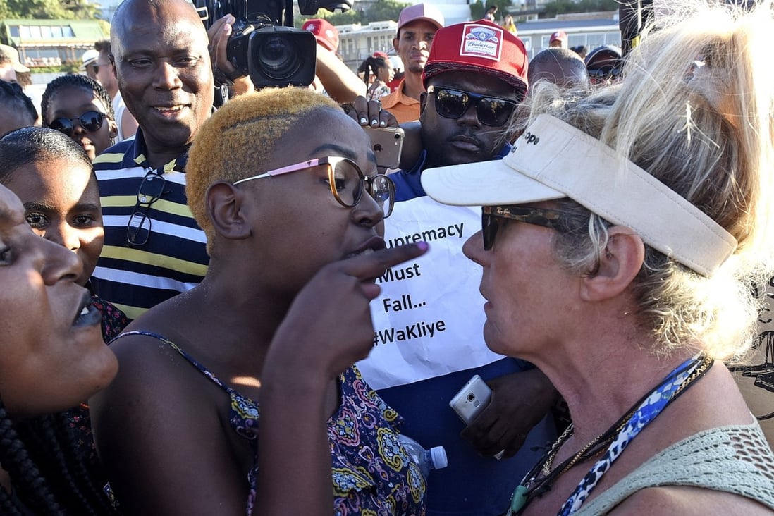 An anti-racism protester (left) argues with an animal-rights activist (right) before the slaughter of a sheep in a supposed anti-racism ritual on Cape Town’s Clifton Beach on Friday. Photo: EPA