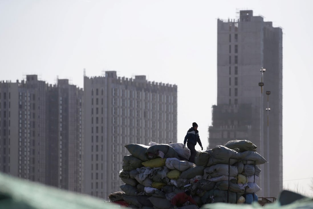 A man works near apartment blocks under construction on the outskirts of Beijing, China December 16, 2017. Photo: Reuters