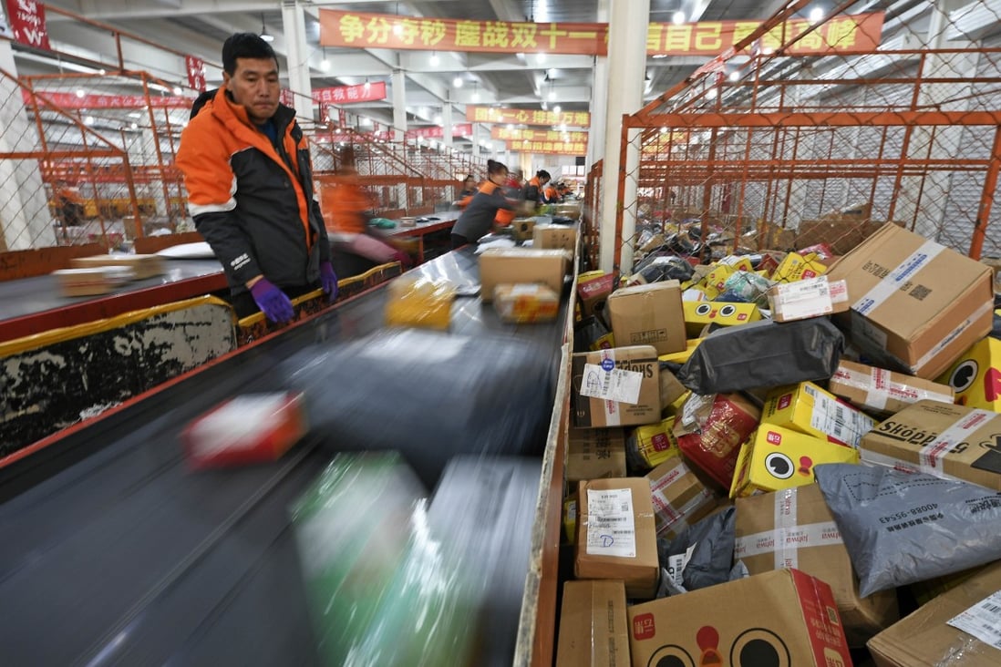 Staff members work at a distribution centre of an express delivery company in northwest China's Ningxia Hui autonomous region. China’s new e-commerce law comes amid the country’s rapid development into the world’s largest e-commerce market, with estimated sales of US$1.53 trillion in 2018. Photo: Xinhua