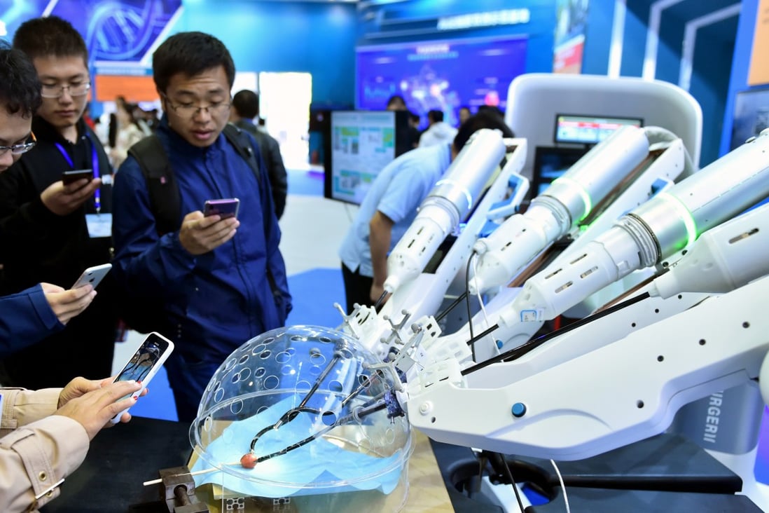 Visitors watch a robot performing surgery during the 2018 national mass innovation and entrepreneurship week in Beijing in October. Photo: Xinhua