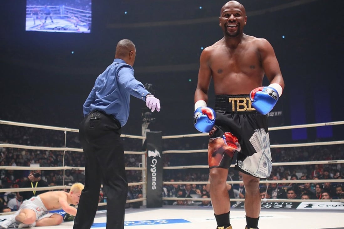 Floyd Mayweather smiles after knocking down Tenshin Nasukawa in the first round at Rizin 14. Photo: Rizin Fighting Federation/Handout via Reuters