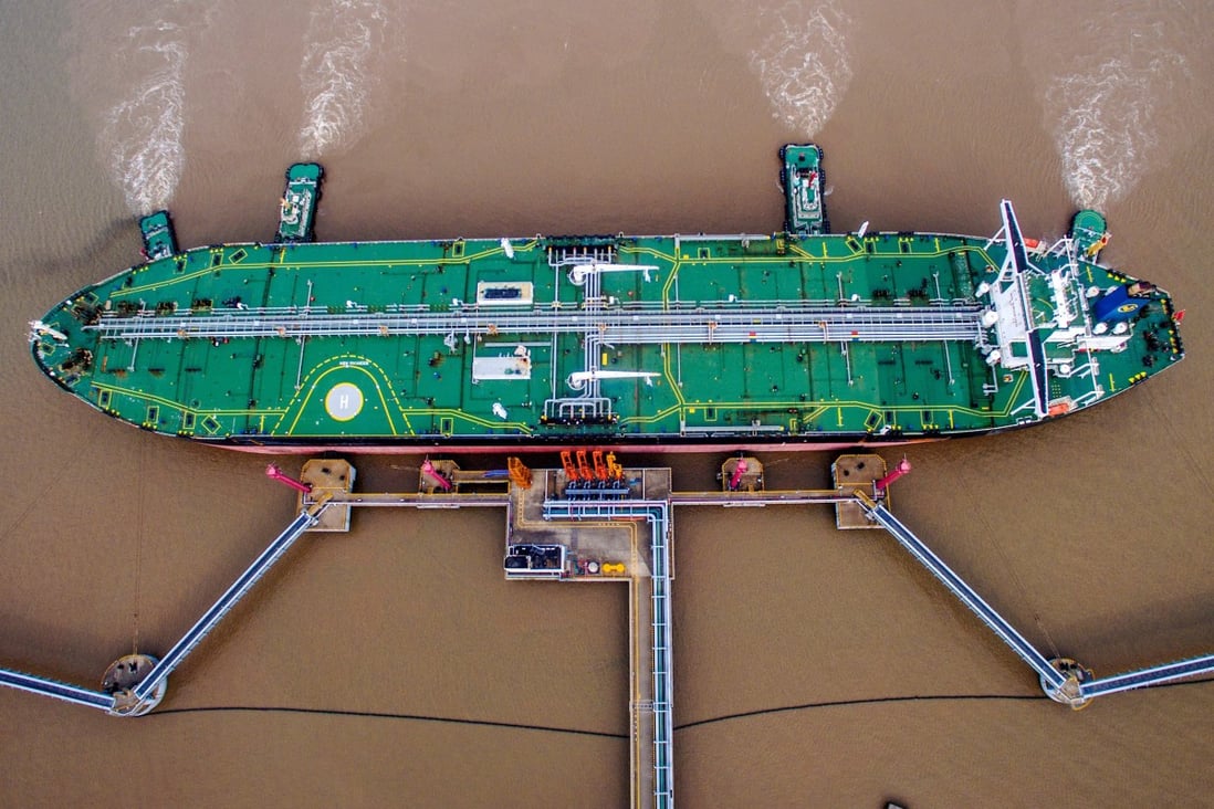 An oil tanker unloads crude at a terminal in Zhejiang province. Private refiners received quotas for 70.65 million tonnes of imports – more than 20 per cent lower than a year ago. Photo: Reuters