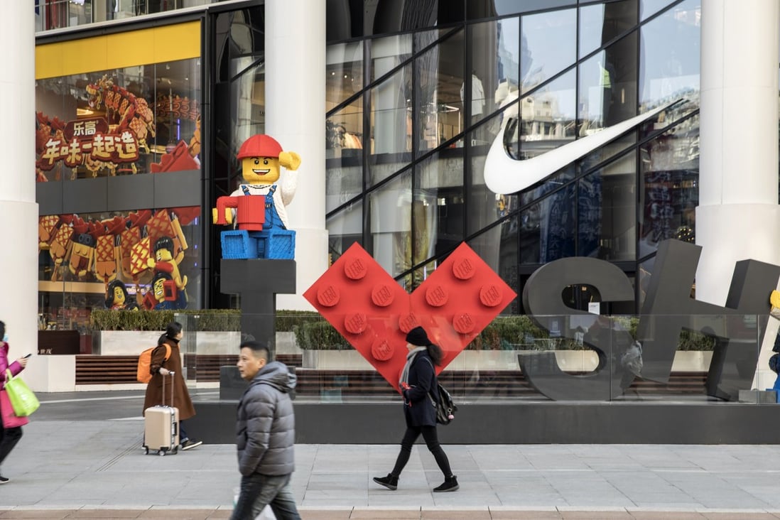 Pedestrians walk past a Lego installation in Shanghai, China, on Friday, Dec. 28, 2018. China announced plans to rein in the expansion of lending by the nation's regional banks to areas beyond their home bases, the latest step policy makers have taken to defend against financial risk in the world's second-biggest economy. Photo: Bloomberg