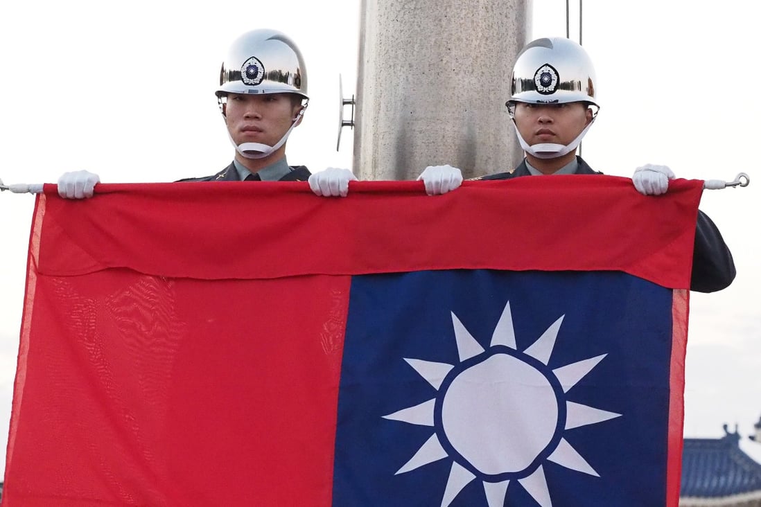Soldiers perform a flag-lowering ceremony in Taipei’s Liberty Square in December. Photo: EPA-EFE