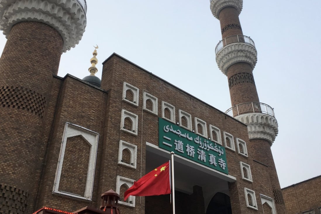 The Chinese national flag flies outside the mosque at the Xinjiang International Grand Bazaar in the regional capital Urumqi. Photo: Reuters
